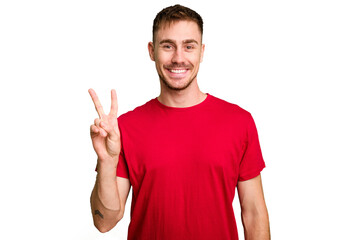 Naklejka premium Young caucasian man cut out isolated showing victory sign and smiling broadly.