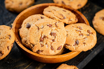 Delicious cookies with pieces of milk chocolate on a plate.