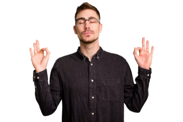 Young caucasian man cut out isolated relaxes after hard working day, she is performing yoga.