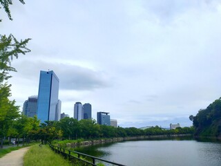 Obraz premium 日本の観光地、大阪城と立ち並ぶビル群が対照的な風景（コピースペースあり）