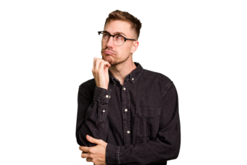 Young caucasian man cut out isolated thinking and looking up, being reflective, contemplating, having a fantasy.