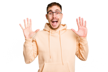 Young caucasian man cut out isolated receiving a pleasant surprise, excited and raising hands.