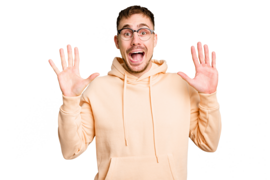 Young caucasian man cut out isolated receiving a pleasant surprise, excited and raising hands.