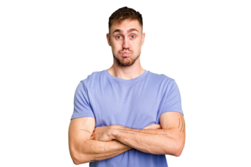 Young caucasian man cut out isolated blows cheeks, has tired expression. Facial expression concept.