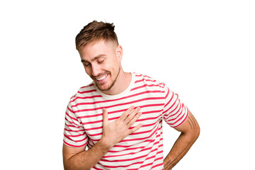 Obraz premium Young caucasian man cut out isolated laughing keeping hands on heart, concept of happiness.