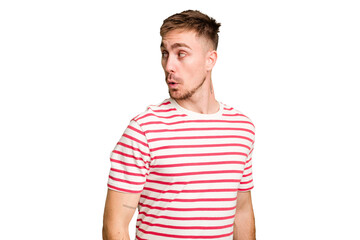 Obraz premium Young caucasian man cut out isolated looks aside smiling, cheerful and pleasant.