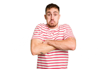 Young caucasian man cut out isolated shrugs shoulders and open eyes confused.