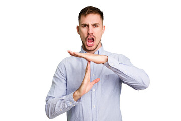 Young caucasian man cut out isolated showing a timeout gesture.
