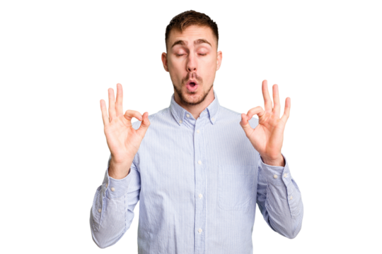 Young caucasian man cut out isolated relaxes after hard working day, she is performing yoga.