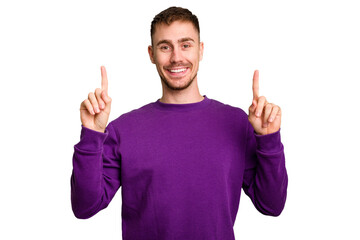 Young caucasian man cut out isolated indicates with both fore fingers up showing a blank space.