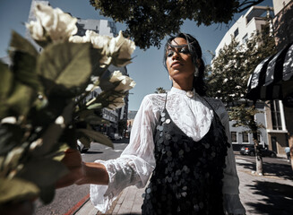 Fashion, young woman in city with rose, nature and urban designer clothes, glamour and creative...
