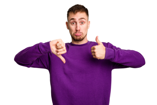 Young caucasian man cut out isolated showing thumbs up and thumbs down, difficult choose concept