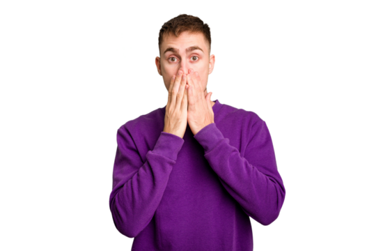 Young caucasian man cut out isolated shocked, covering mouth with hands, anxious to discover something new.