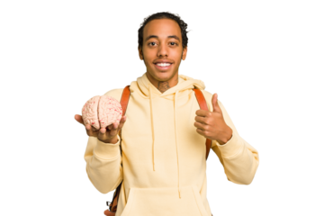 Young African American man holding a brain isolated smiling and raising thumb up