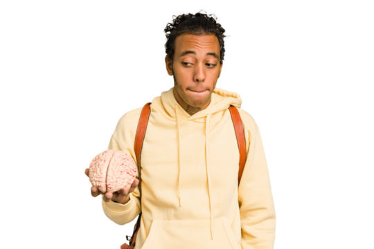 Young African American man holding a brain isolated confused, feels doubtful and unsure.