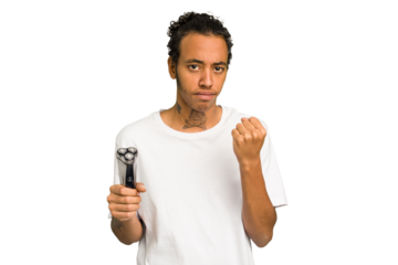 Young African American man holding a razor isolated showing fist to camera, aggressive facial expression.
