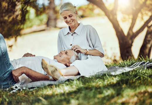 Retirement, Love And Picnic With A Senior Couple Outdoor In Nature To Relax On A Green Field Of Grass Together. Happy, Smile And Date With A Mature Man And Woman Bonding Outside For Romance