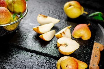 Sliced ripe pear with a knife. 