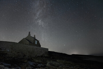 Winter Milky Way rising above a coastal boat house