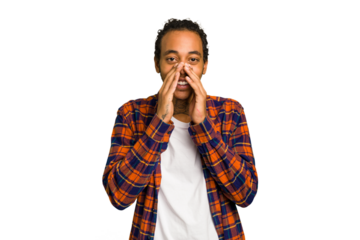 Young African American man isolated saying a gossip, pointing to side reporting something.