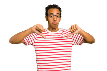 Young African American man isolated showing a dislike gesture, thumbs down. Disagreement concept.