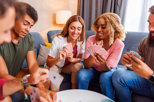 Friends having fun playing cards at home