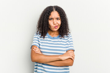 Young african american woman isolated on white background frowning face in displeasure, keeps arms...