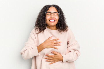 Young african american woman isolated on white background laughs happily and has fun keeping hands...
