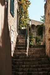 View of stone stairs in the Croatia, summertime, scenery with green windows