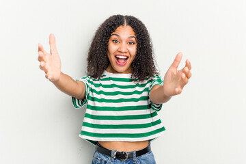 Young african american woman isolated on white background celebrating a victory or success, he is surprised and shocked.