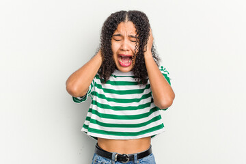 Young african american woman isolated on white background covering ears with hands trying not to hear too loud sound.