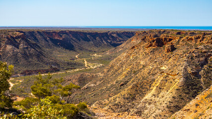 panorama of charles knife canyon in cape range national park in western australia near exmouth; australian outback, red rocks and ocean in the background
