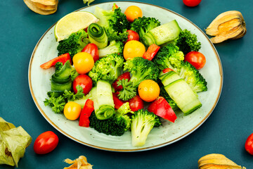 Spring raw salad decorated with physalis.
