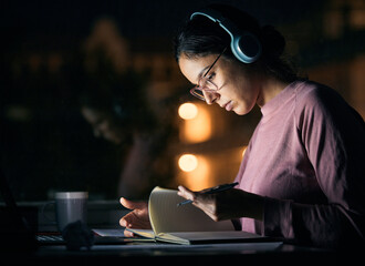 Headphones, research and girl student studying at night for a test, exam or college assignment....