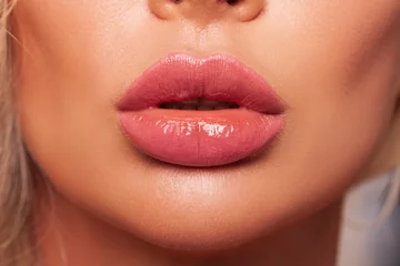 Fotobehang Close up lips. Sexy pink lips close up. Beautiful Perfect Makeup. macro. Beautiful pink Lip Gloss. advertising. Cosmetic. Mouth open, big lips.   © Julia