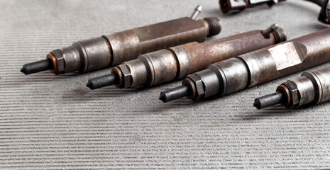 Mechanical injectors from a diesel engine, close-up. Fuel atomization, diesel fuel quality. Close-up, copy space for text