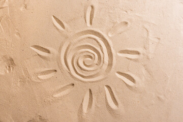 Fototapeta na wymiar Sun symbol on sand