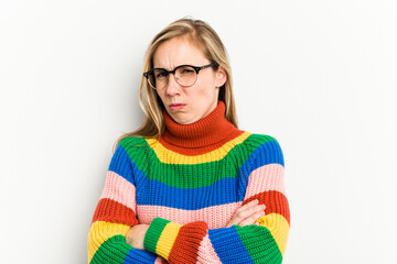 Young caucasian woman isolated on white background frowning face in displeasure, keeps arms folded.