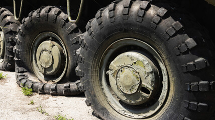 Wheels of armored personnel carriers pierced by bullets during a military battle. Military conflict and weapons. Equipment damage.