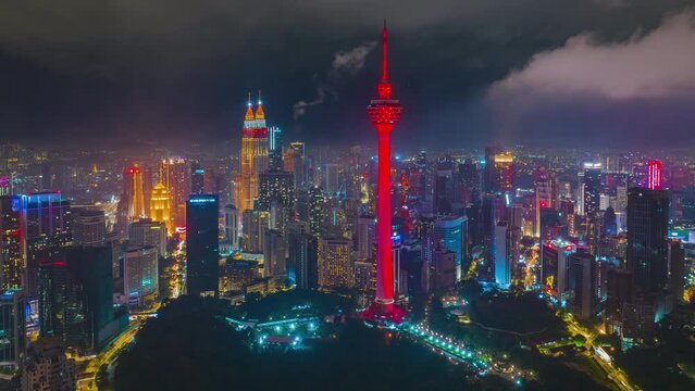 4K aerial hyperlapse of Kuala Lumpur cityscape during Chinese New Year Eve. KLCC and KL Tower lights up red and gold color. Year of the Rabbit