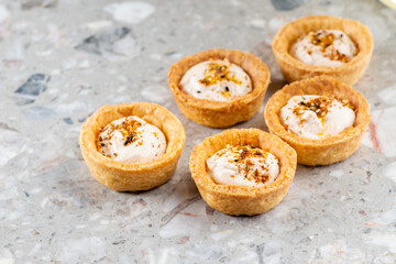 Tartlets with chicken, boiled eggs, spices and herbs. Traditional cold portioned appetizer in a pastry basket.
