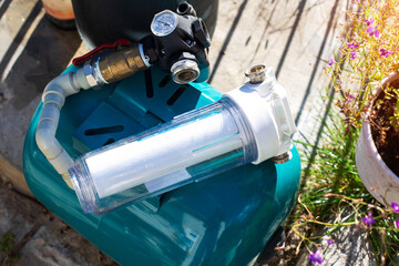 Water supply system with a hydraulic tank and a cleaning filter from a well in the country.