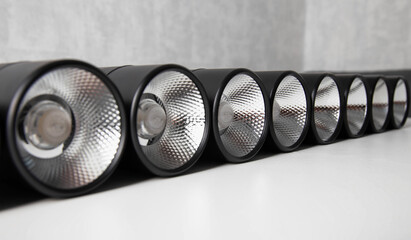 Overhead black LED lamps for a stretch ceiling on a white background. Close-up