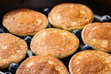 Pancakes with fresh blueberries. Macro background.