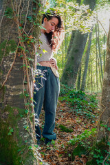 woman looks at the ostomy bag in nature. resilience and courage