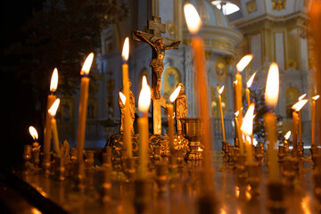 Orthodox church. Christ with crucifix, lit wax candles, a funeral memorial table for the ceremony...
