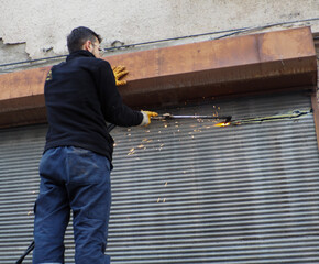 Cutting metal shutters with a gas gun.