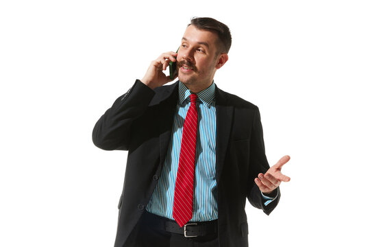 Businessman in a suit talking on phone over white studio background. Making good business proposal. Concept of business, career, innovations, ad