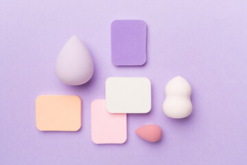 Beauty blenders on color background, top view