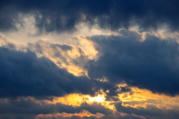 Dark storm clouds in the evening sky during sunset